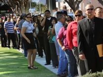 California's unemployment rate increased slightly to 8.7 percent in July, the first such bump since the spring of 2011, state officials announced Friday. The rate from 8.5 percent in June. (File photo: Unemployed Americans line up to enter a job fair in El Monte, Calif.)
