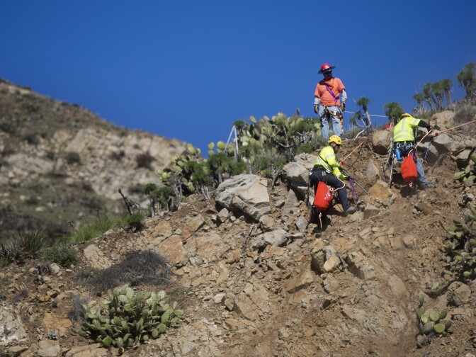 The CalTrans rock scaling crew clears out loose rocks on a 120-foot mountain along the Pacific Coast Highway on Tuesday morning, Jan. 6.