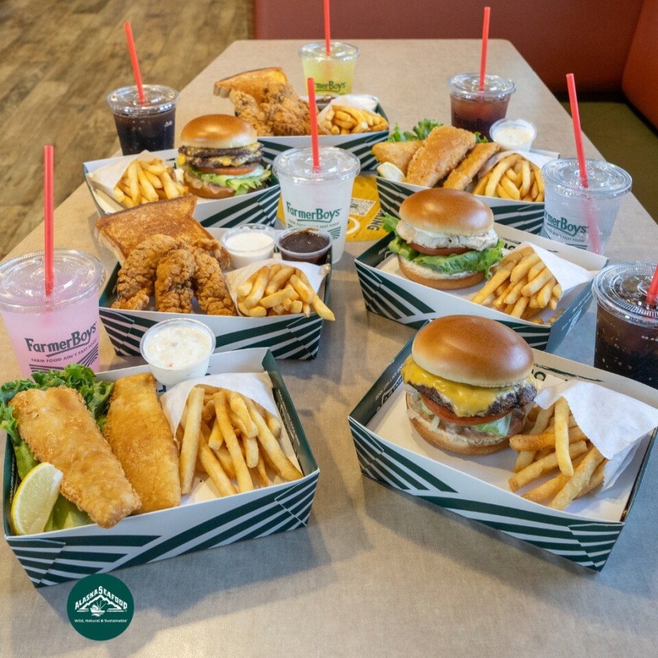 Seven Farmer Boys meals in green and white boxes. There's a mix of burgers, chicken tenders and fish, all with fries and a drink.