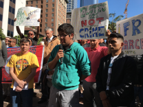 Roberto Rosas Rios, center, speaks at a rally in downtown Los Angeles on Thursday in support of his mother, street vendor Marcelina Rios. The elder Rios was arrested in October in San Bernardino County for illegally doing business as a street vendor. She received a misdemeanor citation and was taken into custody by local authorities, then was picked up by immigration agents. She now faces deportation.