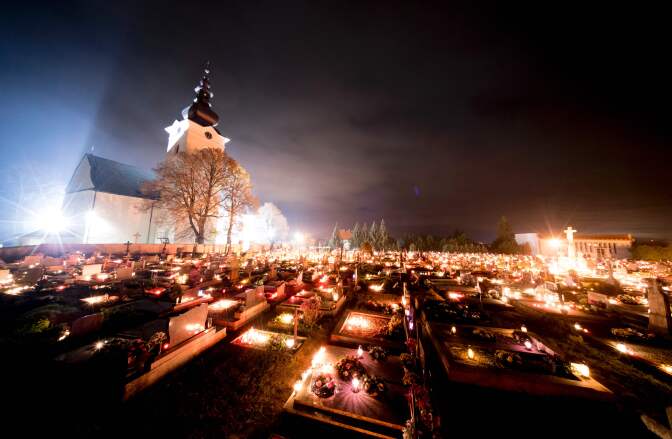 People visit a cemetery to pay respects to their ancestors on All Saints Day in the northern Slovakian village of Bobrovec on November 1, 2016.
