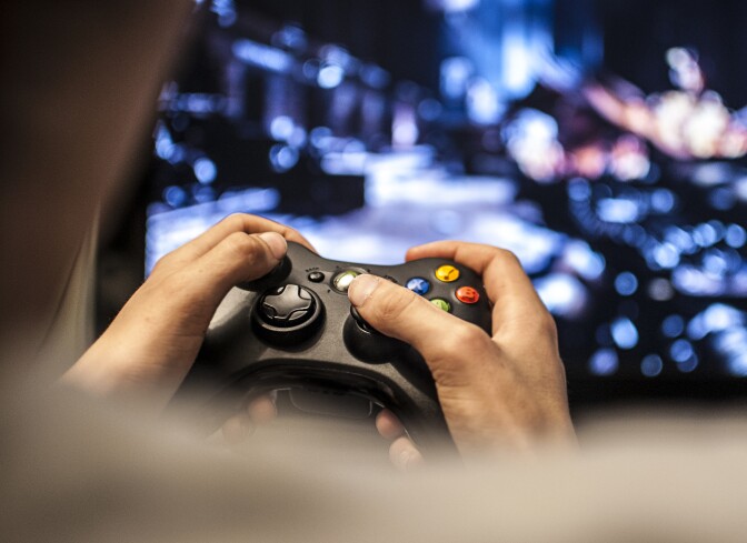 A video game user plays XBOX.