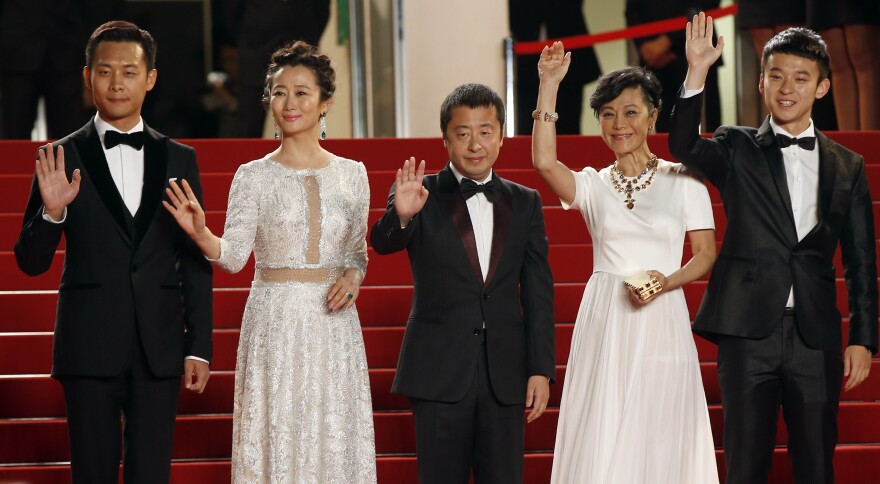 (From L) Chinese actor Zhang Yi, Chinese actress Zhao Tao, Chinese director Jia Zhang-Ke, Chinese actress Chang Sylvia and Chinese actor Dong Zijang wave as they arrive for the screening of the film "Shan He Gu Ren" (Mountains May Depart) at the 68th Cannes Film Festival in Cannes, southeastern France, on May 20, 2015.    AFP PHOTO / VALERY HACHE        (Photo credit should read VALERY HACHE/AFP/Getty Images)
