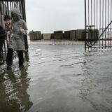 NEW YORK, NY - OCTOBER 29:  People walk through a flooded street as Hurricane Sandy moves closer to the area on October 29, 2012 in the Red Hook section of the Brooklyn borough of New York City. The storm, which threatens 50 million people in the eastern third of the U.S., is expected to bring days of rain, high winds and possibly heavy snow. New York Governor Andrew Cuomo announced the closure of all New York City will  bus, subway and commuter rail service as of Sunday evening.  (Photo by Spencer Platt/Getty Images)