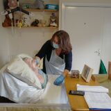 FALMOUTH, ENGLAND - NOVEMBER 25: Della Lilley visits and holds her mother, 89-year old Betty Whiteman, for the first time in two months after successfully passing a rapid Covid-19 test at the King Charles Court Care Home, on November 25, 2020 in Falmouth, England. The home is one of 20 across Cornwall, Hampshire and Devon that are participating in a pilot programme using the Innova SARS-CoV-2 Antigen Rapid Qualitative test to screen residents' family members and friends for Covid-19, to permit more meaningful visits. (Photo by Hugh Hastings/Getty Images)