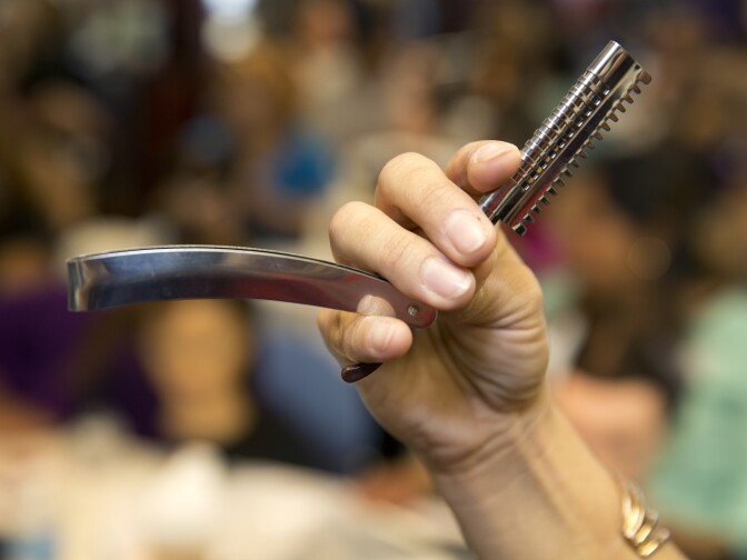Glaricela Acuna demonstrates hair styling technique to her class at Cosmetica on Oct 5, 2015.
