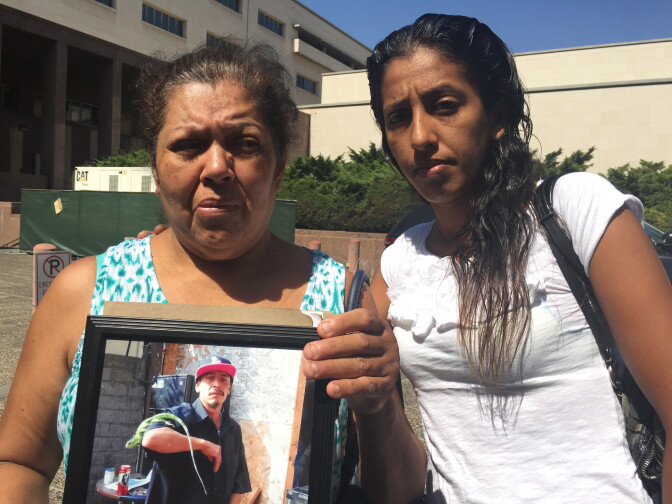 Mona Martinez (left) holds a photo of her son David Coborubio, who was fatally shot by an FBI agent in August.