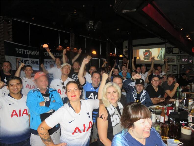 A photo of a crowd of people at a pub.