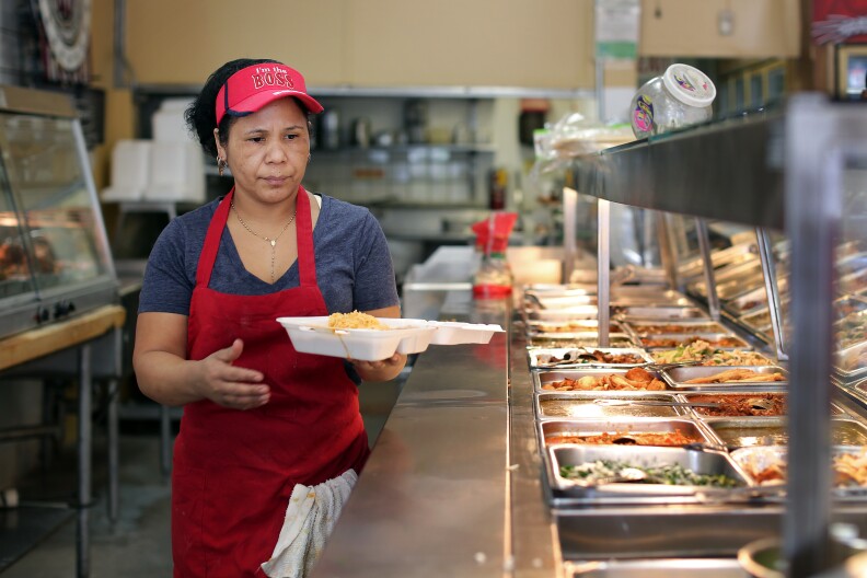 Enedina Arrellano, a cook at Poncitlan Burrito Express in Altadena, makes a to-go order for a customer on Thursday, March 27. The store first opened in 1992 as a convenience store with a meat counter and was called Poncitlan Meat Market.