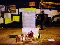A memorial is set up following the fatal shooting of Manuel Jaminez as officers from the Los Angeles Police Department patrol following clashes with protestors, on Sept. 7, 2010 in Los Angeles.