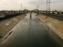 The Los Angeles River flows under the 6th Street Bridge in Los Angeles, California.