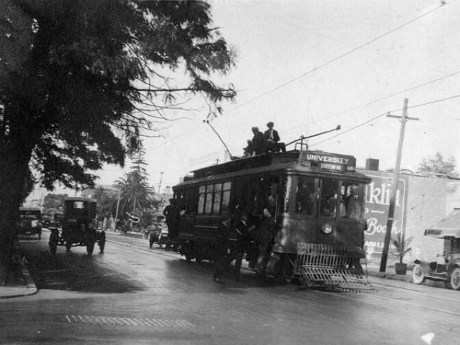 From Sept. 3, 1919: "Overcrowded condition of Los Angeles street car system. Photograph taken at Plaza and Eleventh Street and Flower Street. Automobiles and trees."