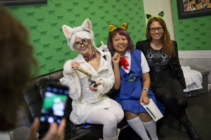Athena Stamos, left, dressed as Chemistry Cat, Linda Trujillo, dressed as Haru Yoshioka from "The Cat Returns," and Kendra Guffey pose for a photo during the first-ever CatConLA at The Reef on Saturday, June 6, 2015.