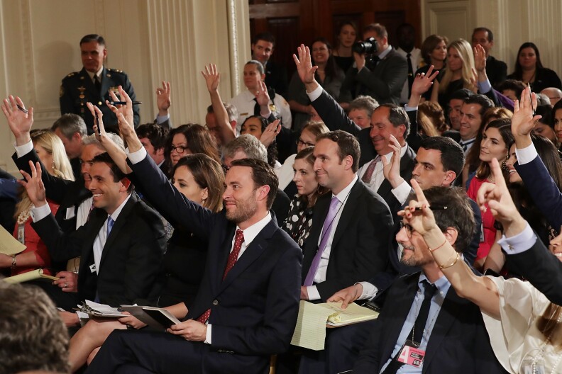 WASHINGTON, DC - MAY 18: Reporters raise their hands to ask questions during a news conference with Colombian President Juan Manuel Santos and U.S. President Donald Trump in the East Room of the White House May 18, 2017 in Washington, DC. The Trump administration has said it wants to slash foreign aide and Santos will most likely seek a renewal of $450 million dollars from the U.S. that supports the peace accord between the Columbian government at the Revolutionary Armed Forces (FARC). (Photo by Chip Somodevilla/Getty Images)