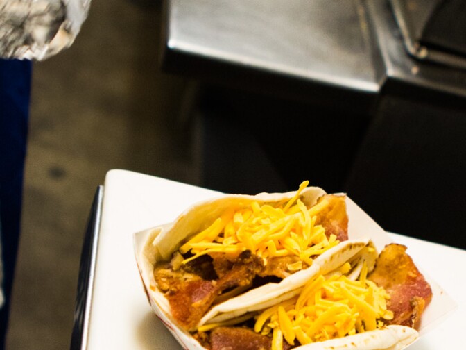 Breakfast tacos full of cheese, eggs, bacon and beans in flour tortillas at Joe's Bakery in Austin, Texas.