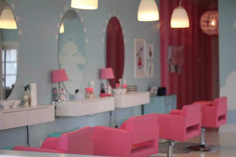 Blue walls, pink chairs inside Hair Angels lice removal salon. 