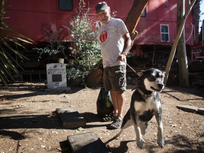 Nick Nomic takes a walk with his dog butterfly at the Rubel Castle on August 16th, 2013. Nomic has been the caretaker of the Rubel Castle for the past six years.