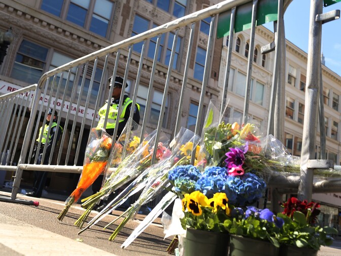 Flowers are left at a security gate near the scene of Monday's bombing at the Boston Marathon on April 16, 2013 in Boston, Massachusetts.