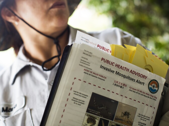 Maria Rodriguez, a seasonal technician part of Orange County Vector Control's Aedes investigation team, holds fliers that staffers hand out at Anaheim residences on Feb. 17, 2016. The department is working to set up Zika virus testing in-house, which would greatly increase turnaround time for test results.