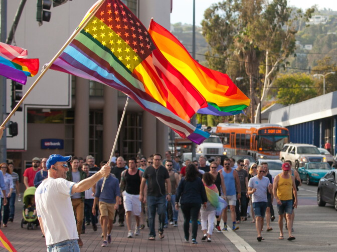 Crowds waved a rainbow-clad American flag at the Decision Day Rally in West Hollywood Park on Friday, June 26, 2015.