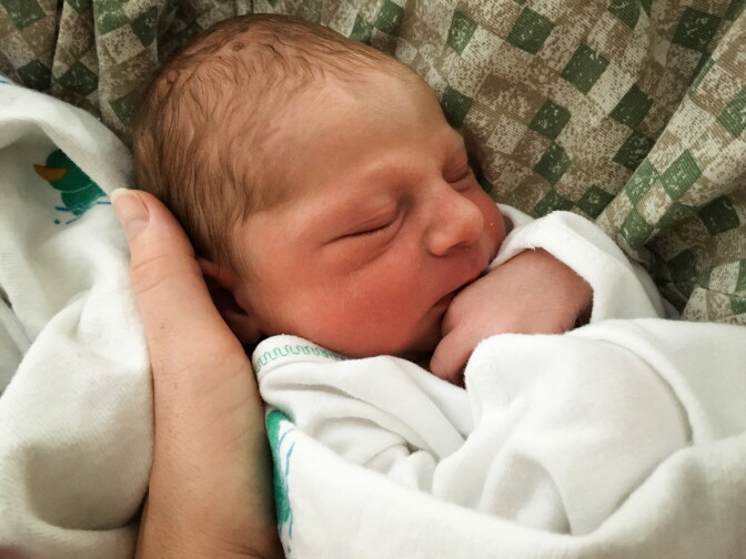 Ethan Thomas gets a cuddle from mom Amy Marks, who used laughing gas during labor.