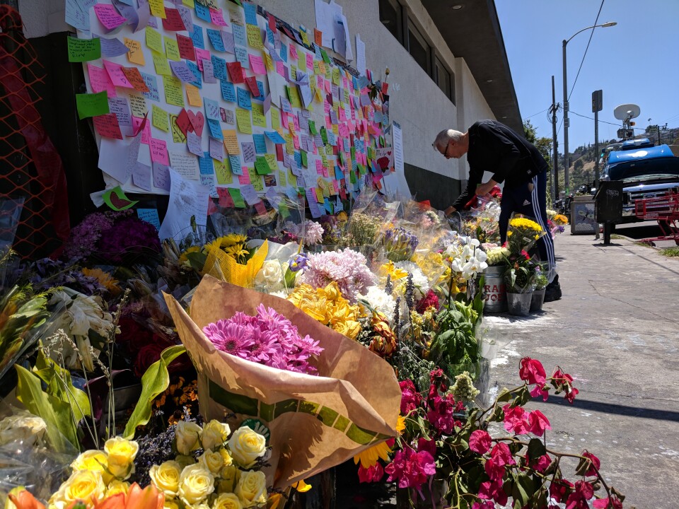 Flowers and messages in memoriam line a wall at the Silver Lake Trader Joe's where an assistant manager was killed on July 21, 2018 during a police shootout with a suspect.