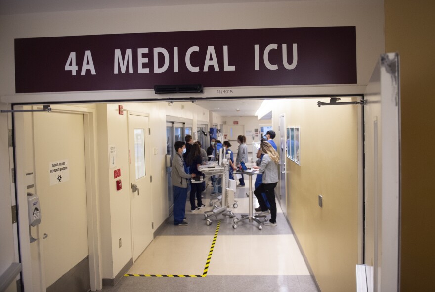 An image of hospital workers in a hallway of an intensive care unit.