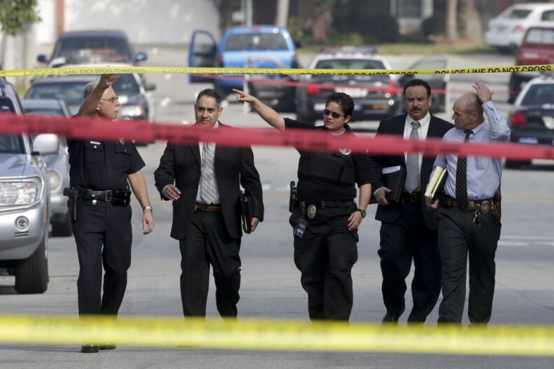 Law enforcement members look over the scene of an officer involved shooting in Torrance, Calif. Thursday, Feb. 7, 2013. Thousands of police officers throughout Southern California and Nevada hunted for a former Los Angeles officer, Christopher Dorner, who was angry over his firing and began a deadly shooting rampage that he warned in an online posting would target those on the force who wronged him, authorities said.