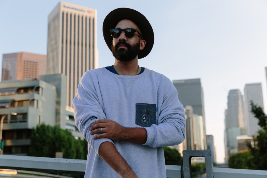 Povertees is an L.A.-based company that works out of Highland Park. This photo shows a man wearing Povertees merchandise.