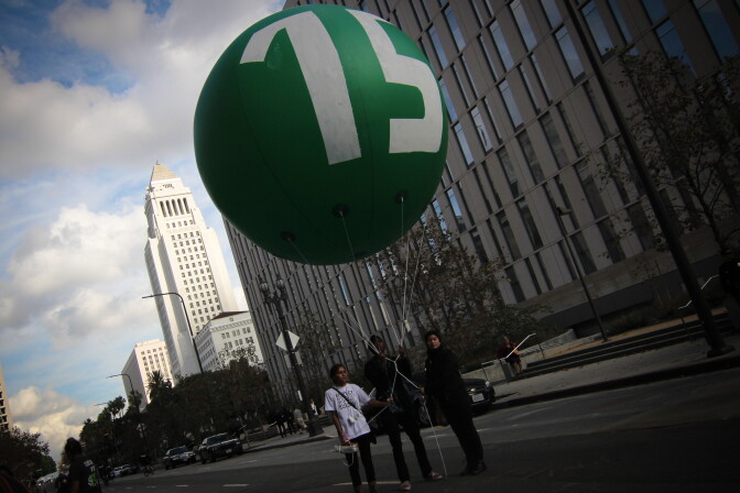 The Los Angeles City Council on Tuesday, May 19, 2015, approved a proposal that calls for raising the city’s minimum wage to $15 an hour by 2020. (File photo shows balloon used during a rally and march to demand the increase to $15.)