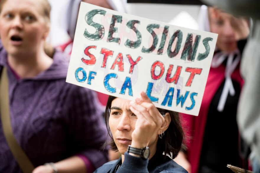 People protest outside a speech by US Attorney General Jeff Sessions March 7, 2018, in Sacramento, California. Sessions admonished California politicians for not cooperating with federal authorities on immigration enforcement issues.
US Attorney General Jeff Sessions warned California Wednesday that the federal government would use all its legal powers to fight protections provided unauthorized immigrants, a day after suing the state over its sanctuary laws."California is using every power it has -- and some it doesn't -- to frustrate federal law enforcement. So you can be sure I'm going to use every power I have to stop them," Sessions told law enforcement officials in Sacramento.
 / AFP PHOTO / NOAH BERGER        (Photo credit should read NOAH BERGER/AFP/Getty Images)