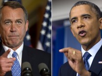 U.S. Speaker of the House John Boehner (L) speaks at the U.S. Capitol in Washington, D.C., Oct. 8, 2013, following a press conference by US President Barack Obama (R) at the White House as the crisis over a U.S. government shutdown and debt ceiling standoff deepens on the 8th day of the shutdown.