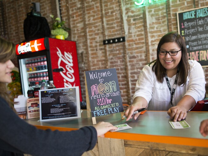 Co-owner Mia Mazadiego helps customers at Neon Retro Arcade in Pasadena on Wednesday afternoon, Feb. 4. The space opened in Old Town on Jan. 30.