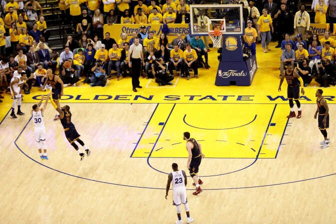 OAKLAND, CA - JUNE 02:  Stephen Curry #30 of the Golden State Warriors shoots a three pointer over Kyrie Irving #2 of the Cleveland Cavaliers in Game 1 of the 2016 NBA Finals at ORACLE Arena on June 2, 2016 in Oakland, California. NOTE TO USER: User expressly acknowledges and agrees that, by downloading and or using this photograph, User is consenting to the terms and conditions of the Getty Images License Agreement.  (Photo by Ezra Shaw/Getty Images)