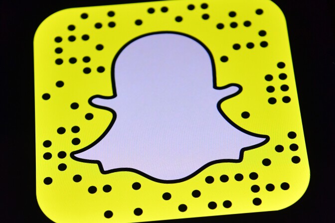 File: The Snapchat app logo is displayed on an iPad on Aug. 3, 2016 in London, England.
