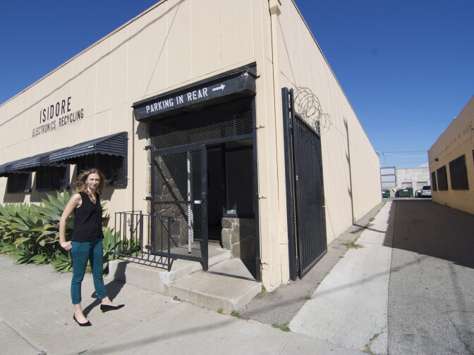 Founder/CEO Kabira Stokes stands in front of the Isidore Recycling building. 