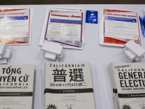Voter registration and sample pamphlets in multiple languages were available after a naturalization ceremony at the L.A. Convention Center.