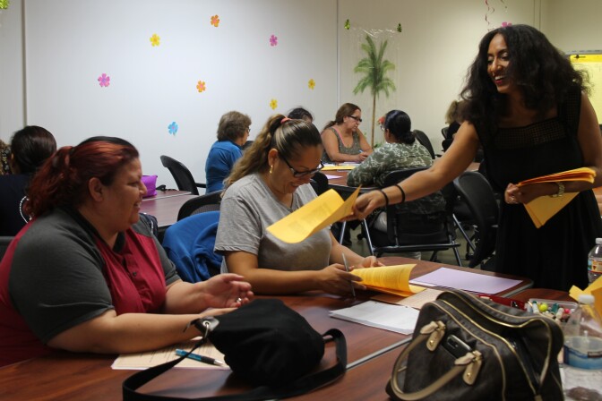 Christine Wilson, an adjunct professor with Los Angeles Trade Technical College, hands out a syllabi for her Infant and Toddler course.