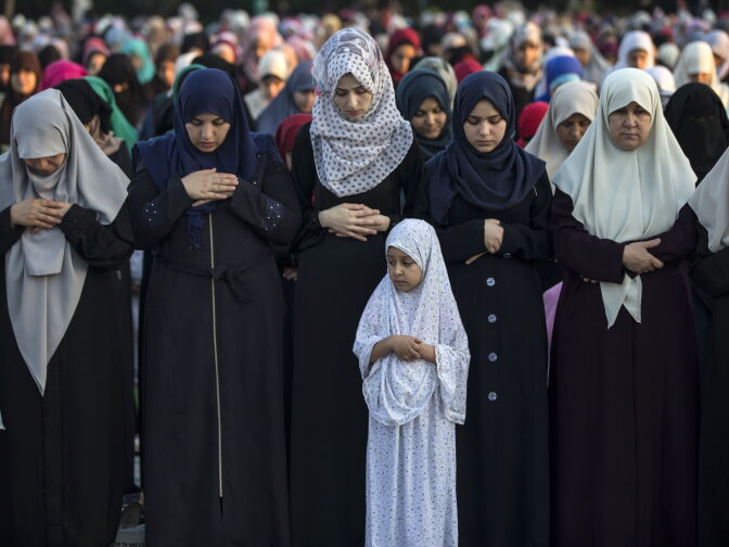 Palestinian Muslims attend the Eid al-Fitr prayer in open area in Gaza city on June 25, 2017. 
Eid al-Fitr festival marks the end of the holy Muslim fasting month of Ramadan during which devotees are required to abstain from food, drink and sex from dawn to dusk. / AFP PHOTO / MAHMUD HAMS        (Photo credit should read MAHMUD HAMS/AFP/Getty Images)