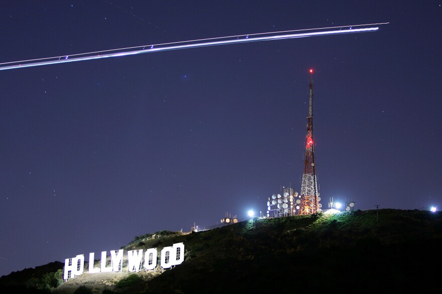 The Hollywood Sign is illuminated by the spotlight of a helicopter streaking past the sign at night on November 16, 2005 in Los Angeles, California.