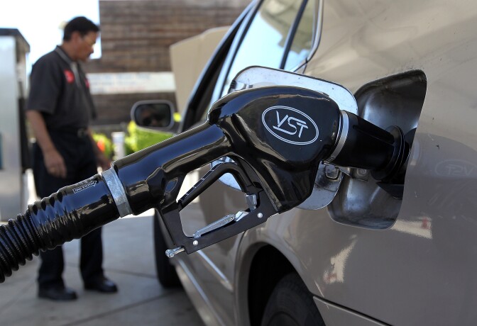 A gasoline pump rests in the tank of a car on June 12, 2012 in San Anselmo, California.  