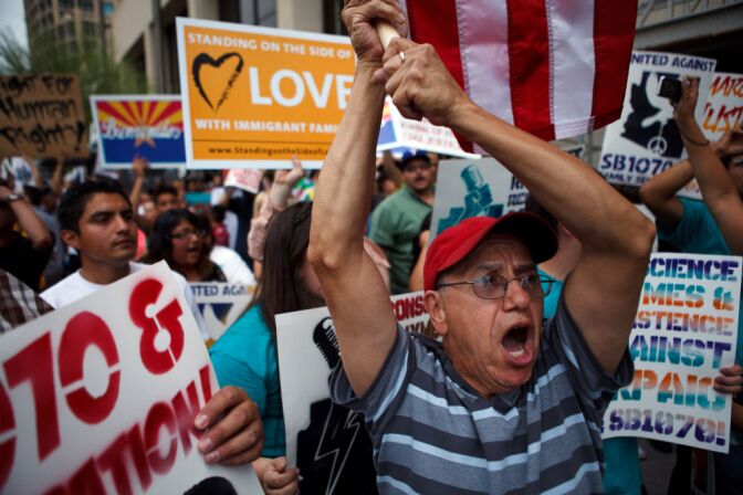 Protesters opposed to Arizona's Immigration Law SB 1070 march through downtown Phoenix April 25, 2012 in Phoenix. The U.S. Supreme Court has struck down most of the provisions in SB 1070 Monday. 