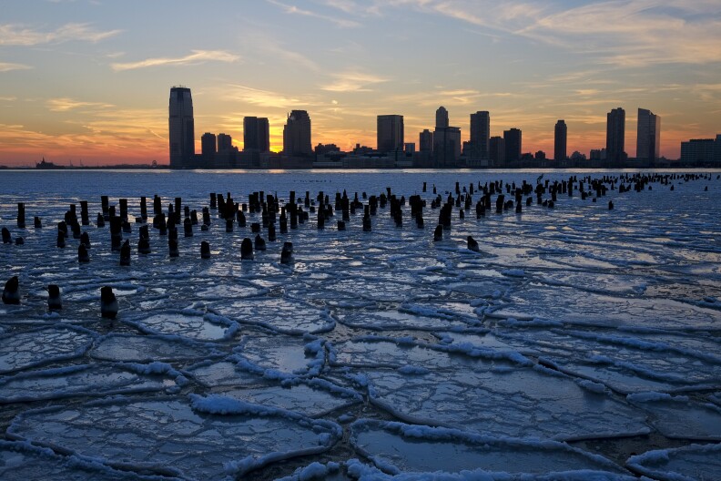 Ice floes fill the Hudson River as the New Jersey waterfront is seen during sunset on January 9, 2014 in New York City. A recent cold spell, caused by a polar vortex descending from the Arctic, caused the floes to form in the Hudson.