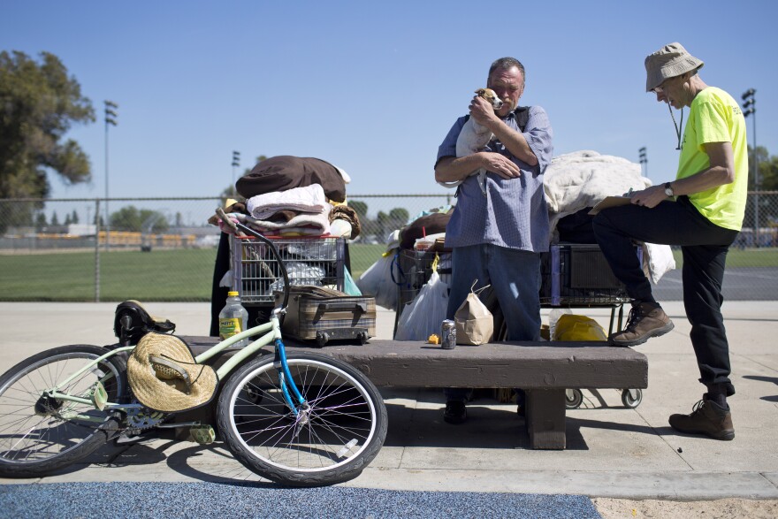 Volunteer Philip Armstrong, right, works with Kenneth Reynolds during a weekly outreach assessment put on by the Coast to Coast Foundation in partnership with the Fullerton Police Department on Thursday, March 5, 2015 at Pacific Drive Park.