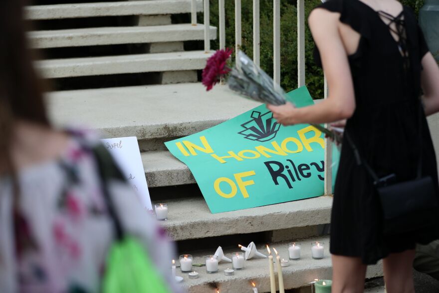 Students lay candles and flowers at the steps of Kennedy Hall to honor the victims of a shooting the day earlier at the University of North Carolina Charlotte, in Charlotte, North Carolina on May 1, 2019. - A 21-year-old student gave his life to save others by tackling a gunman who was shooting up a university classroom, police in the US said May 1, 2019.  Charlotte-Mecklenburg Police Chief Kerr Putney said the authorities were still trying to find a motive for Tuesday's attack at the University of North Carolina, which left undergraduate Riley Howell and another student dead. (Photo by Logan Cyrus / AFP)        (Photo credit should read LOGAN CYRUS/AFP/Getty Images)