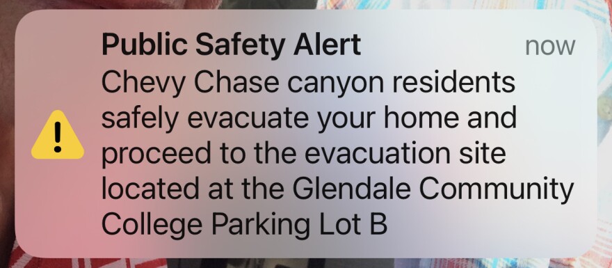 A text message reads Public Safety Alert Chevy Chase canyon residents safely evacuate your home and proceed to the evacuation site located at the Glendar Community College Parking Lot B