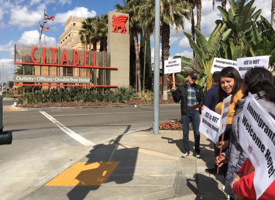 Immigrant advocates outside the Citadel outlet mall in Commerce this week, where immigration agents visited a restaurant to gather work documents as they audit local businesses.