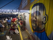 File: Protesters gather in front of a mural painted on the wall of the convenience store where Alton Sterling was shot and killed, July 6, 2016 in Baton Rouge, Louisiana. Sterling was shot by a police officer in front of the Triple S Food Mart in Baton Rouge on Tuesday, July 5, leading the Department of Justice to open a civil rights investigation.