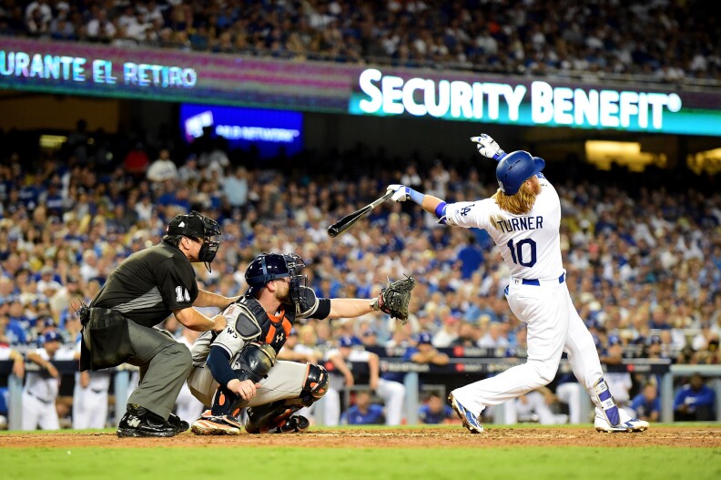 LOS ANGELES, CA - OCTOBER 24:  Justin Turner #10 of the Los Angeles Dodgers hits a two-run home run during the sixth inning against the Houston Astros in game one of the 2017 World Series at Dodger Stadium on October 24, 2017 in Los Angeles, California.  (Photo by Harry How/Getty Images)