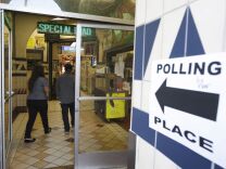 A sign points the way to a polling place inside El Mercado de Los Angeles, a Mexico-style marketplace in the East L.A. area during the U.S. presidential election on November 6, 2012.